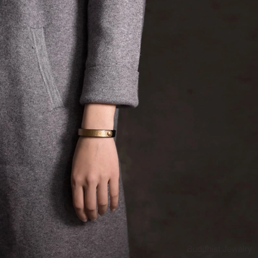 Handmade leather brass bangle featuring natural material variations and authentic vintage-inspired design