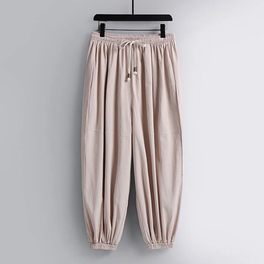 Cropped harem pants with drawstring elastic waist and tapered ankle cuffs – front view hanging