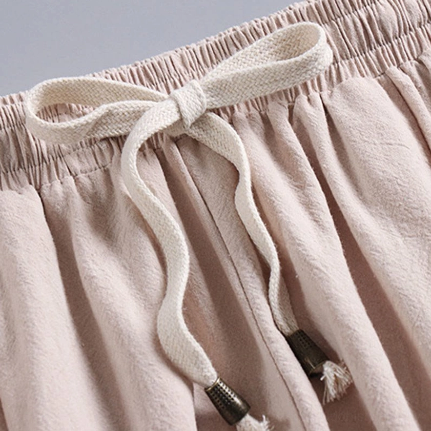 Pants waistband with braided drawstring and tassel – elasticated waist detail close-up