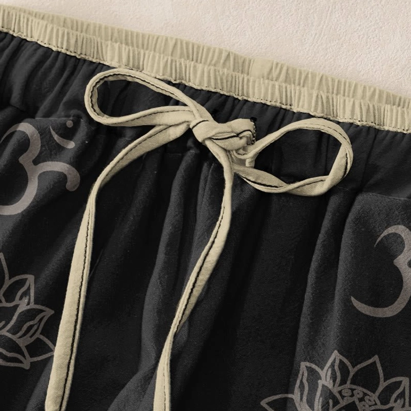 Close-up detail of elastic drawstring waistband with beige trim on printed harem pants