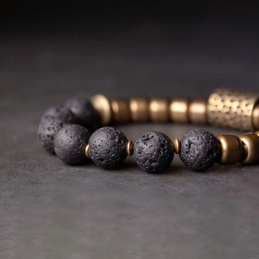 Close-up side profile of lava rock brass bracelet displaying individual bead spacing and stone surface porous texture