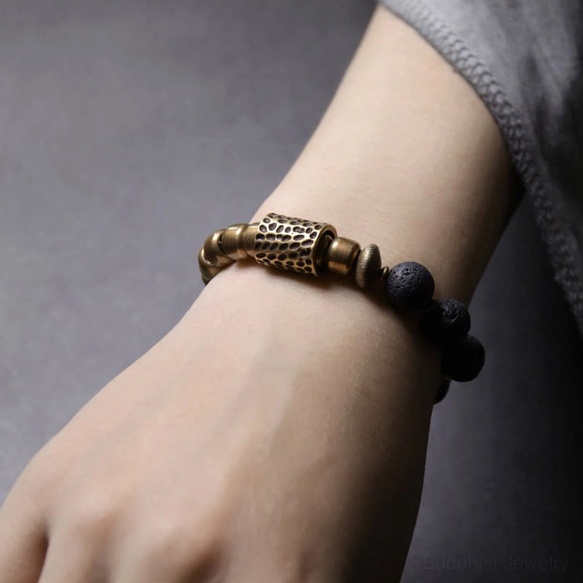 Lava rock and brass healing bracelet worn on wrist, real-life styling showing comfortable fit and visual effect on the hand