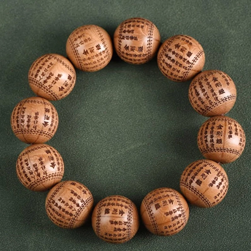 Smaller wooden prayer bracelet with full Heart Sutra text engraved on beads with warm brown tone