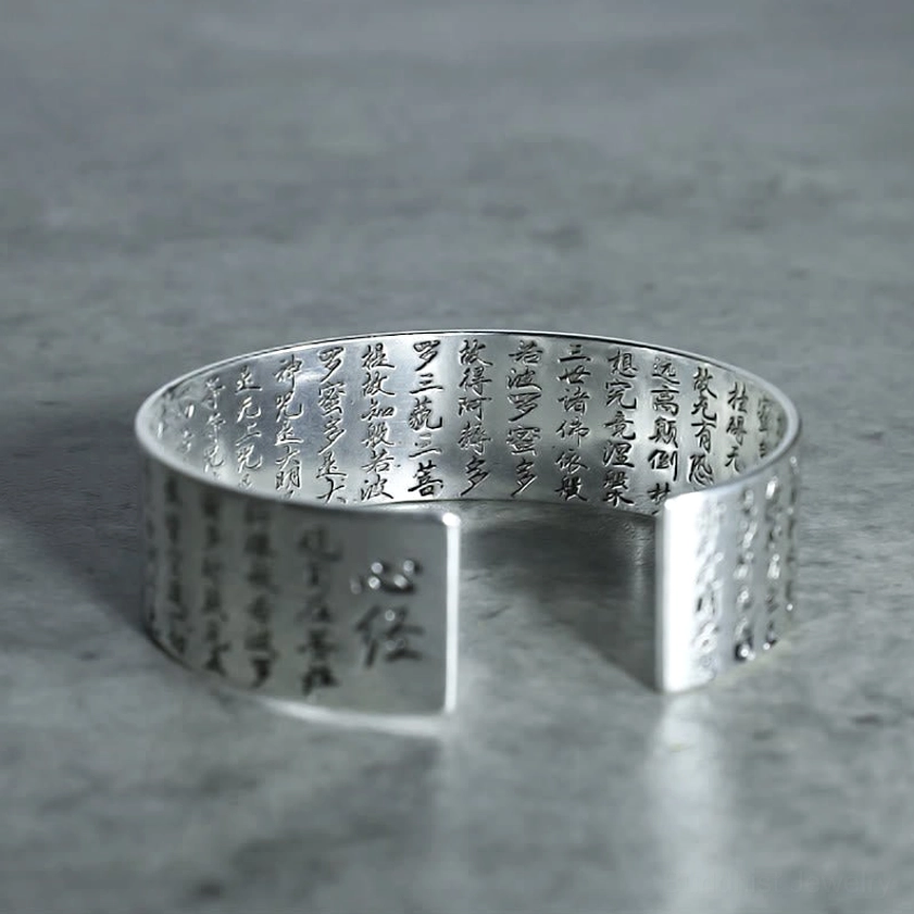Sutra engraved white copper Buddhist bracelet low front angle view featuring Heart Sutra text on outer band with polished silver-like finish
