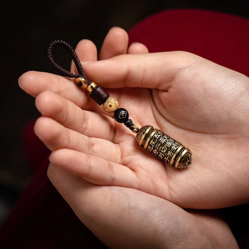 Heart Sutra Buddhist keychain in palm showing different holding angle and design perspective