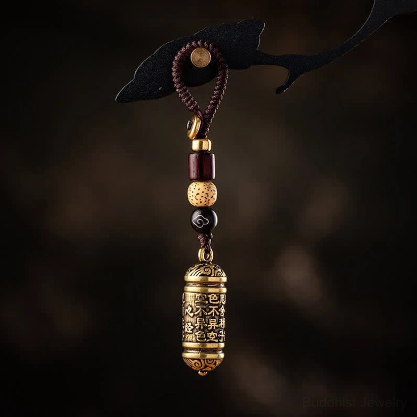 Heart Sutra copper keychain with compact brass pendant and matching braided cord detail