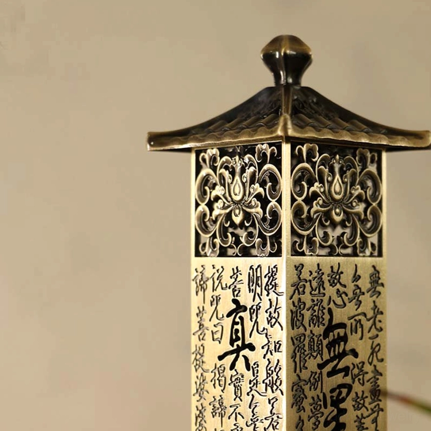 Heart Sutra incense burner side view with engraved Buddhist scripture lines and hollowed floral details