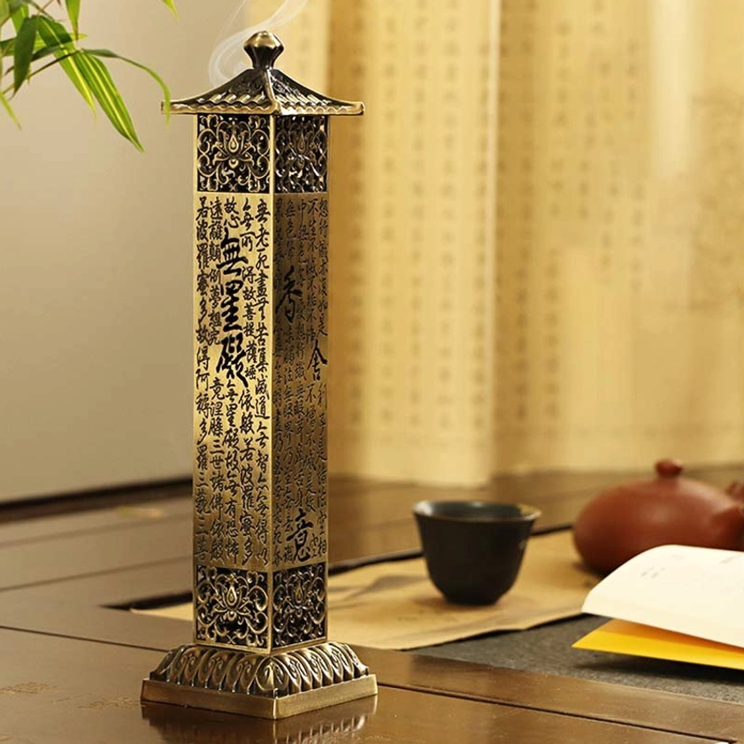 Heart Sutra incense burner with burning incense smoke, pagoda lid, and engraved scriptures in study room