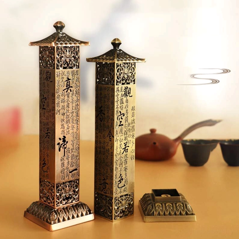 Pair of Heart Sutra incense burners on zen meditation tea table with hollowed Buddhist scripture patterns