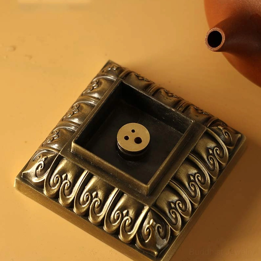 Square incense holder base with carved floral border and dual incense plug holes for meditation