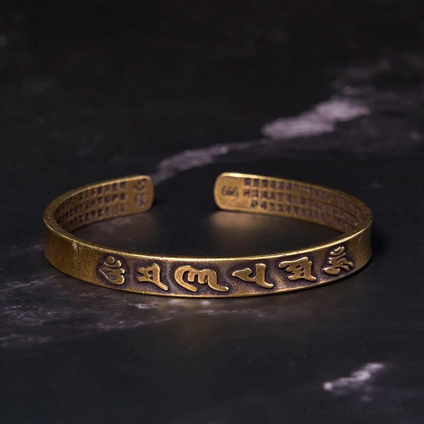Heart Sutra engraved on interior of Buddhist mantra cuff bracelet, brass antique finish, overhead view showing adjustable open-end construction