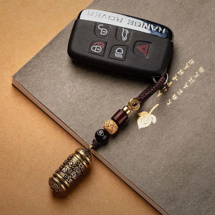 Heart Sutra Buddhist keychain attached to car key and notebook, practical everyday use