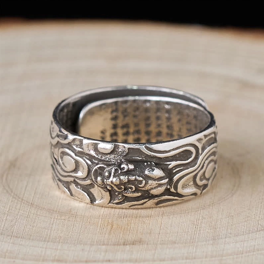 Detail shot of Heart Sutra laser engraving on Buddhist Pixiu prosperity ring, showcasing sacred Sanskrit and Chinese characters