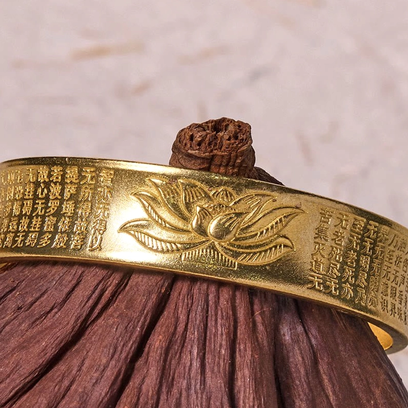 Heart Sutra lotus open cuff bangle bracelet showing adjustable fit and detailed Buddhist lotus engraving in brass metal