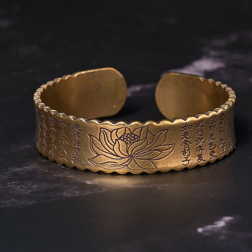 Top-down view of Heart Sutra lotus Buddhist cuff bracelet featuring engraved Heart Sutra inscription and decorative lotus on bronze finish scalloped rim