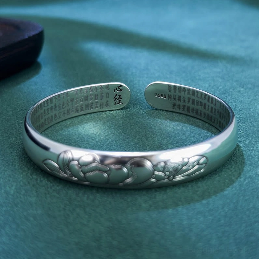 Buddhist lotus copper bangle bracelet front flat view showing matte silver finish with outer lotus engraving and inner Heart Sutra text and silver mark