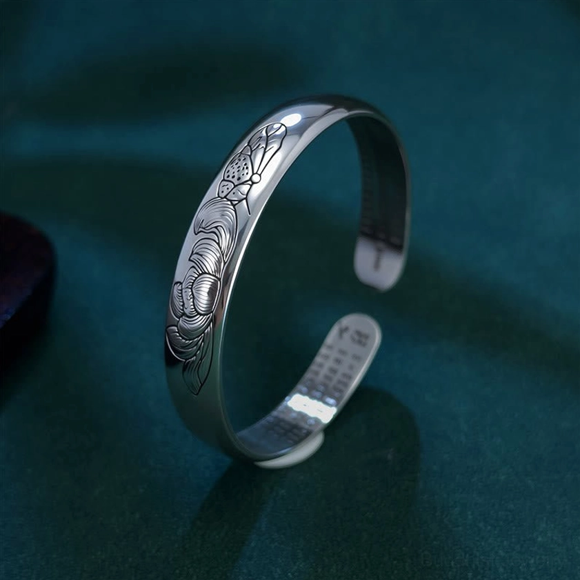 Adjustable copper lotus bracelet right side view displaying embossed full lotus pattern on outer band with engraved Buddhist scripture on inner side