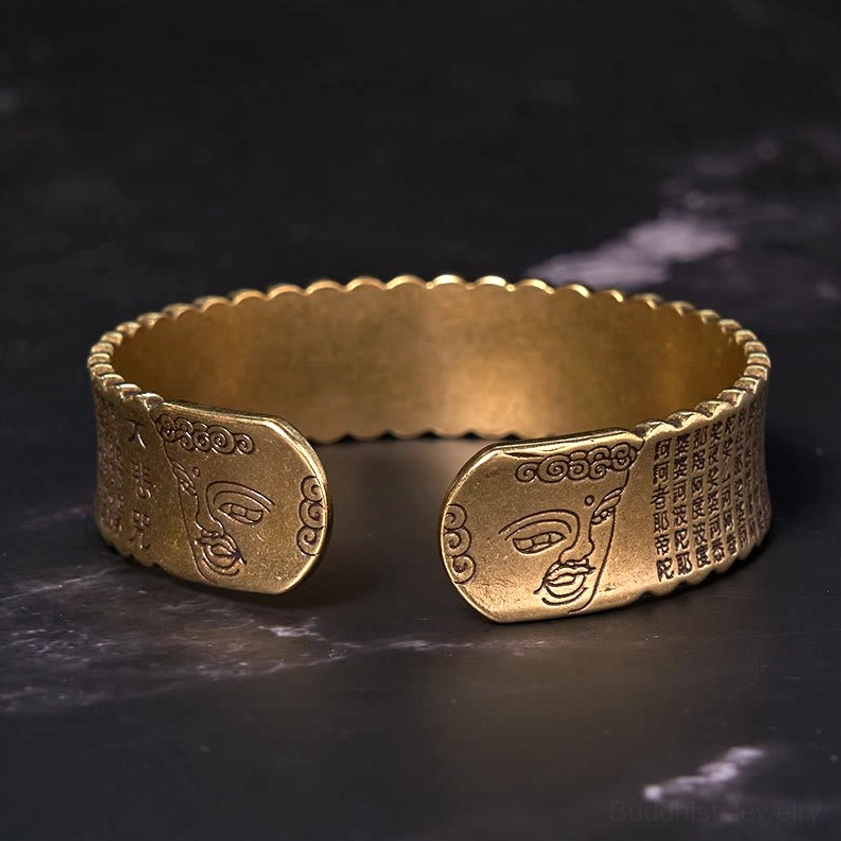 Heart Sutra lotus open cuff bracelet with Buddha face relief and engraved sutra text on cuff ends, bronze finish