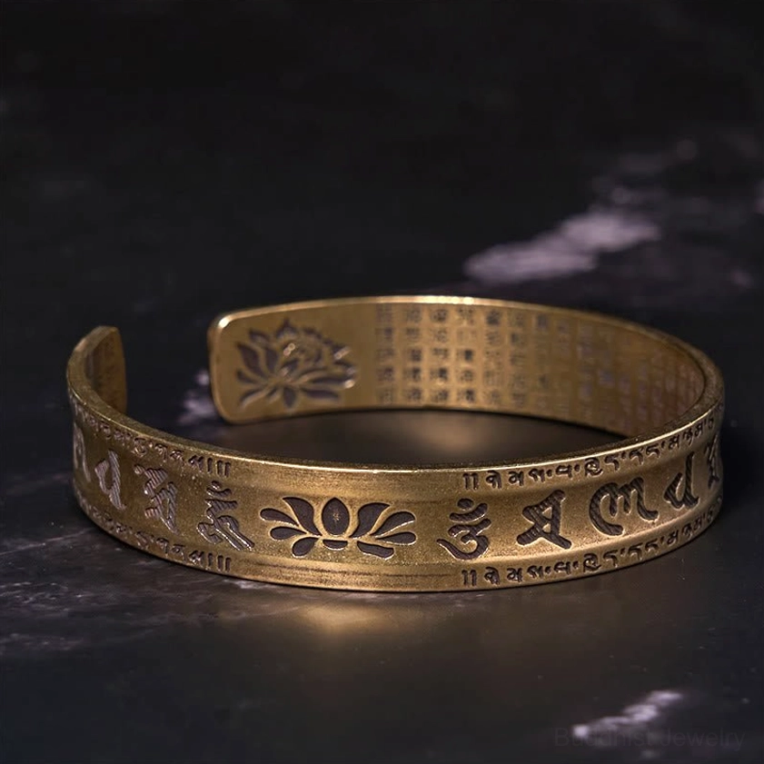 Heart Sutra lotus cuff bracelet top-down view showing intricate Sanskrit engraving and spiritual design