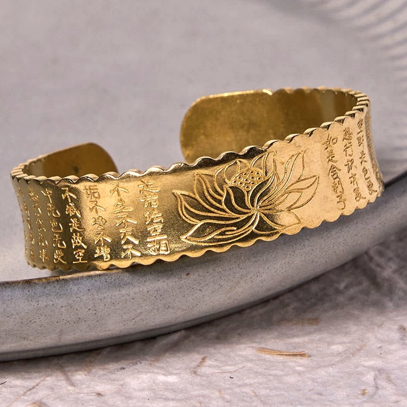 Heart Sutra lotus open cuff bracelet vintage finish showing patina and detailed lotus and sutra engraving on Buddhist bangle