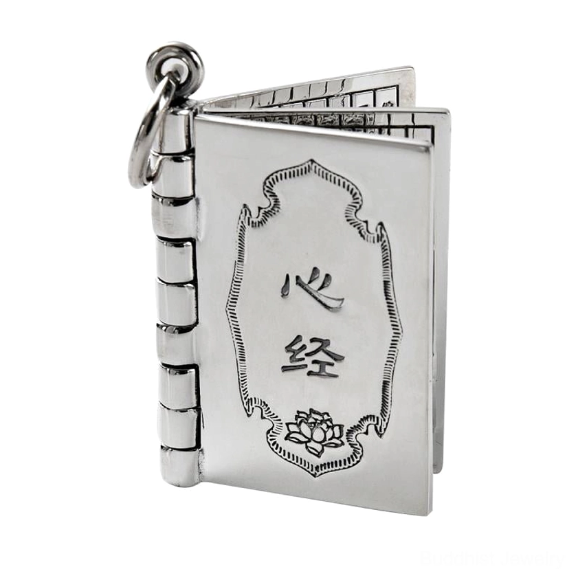Closed silver Heart Sutra book pendant with engraved lotus pattern and Buddhist characters on light gray background