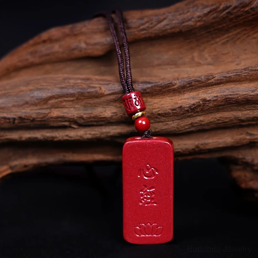 Heart sutra pendant stone showing engraved lotus and sacred Buddhist characters