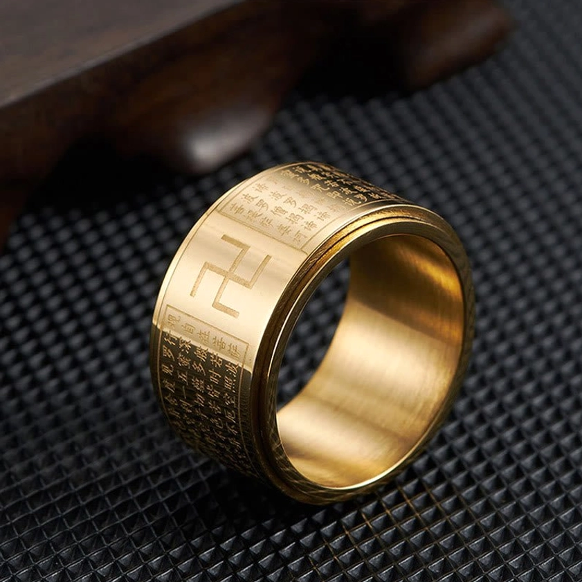 Close-up side view of gold Heart Sutra Swastika rotatable ring showing polished finish and detailed engraved Buddhist mantra