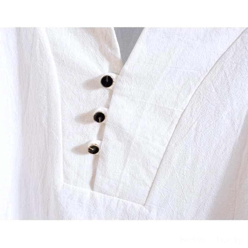 Henley neckline and button placket close-up detail black buttons linen texture