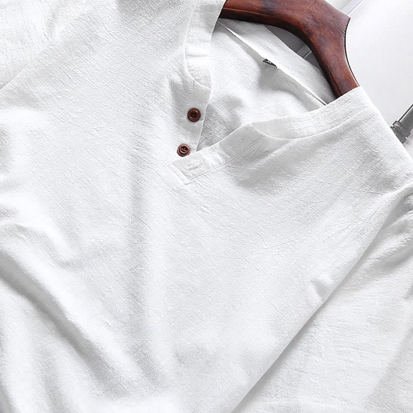 Close-up of white henley v-neck placket and front detail on meditation shirt