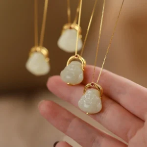 Multiple Hetian jade Laughing Buddha necklaces with sterling silver chains displayed overhead in warm lighting