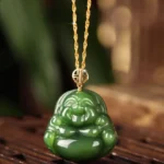 Hetian jade laughing Buddha necklace front view with 925 sterling silver chain and 18K gold clasp on wooden display
