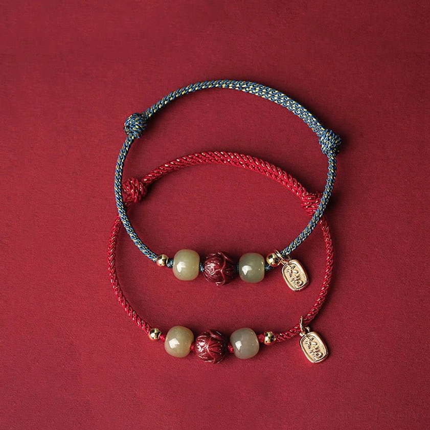 Stacked double Buddhist bracelets with red and blue-gray braided cords, matching Hetian jade and cinnabar lotus beads, gold spacers, spiritual wellness jewelry