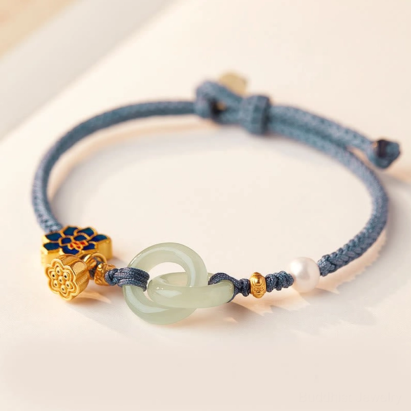 Hetian jade peace buckle lotus bracelet in blue braided cord with gold lotus charm and pearl accent