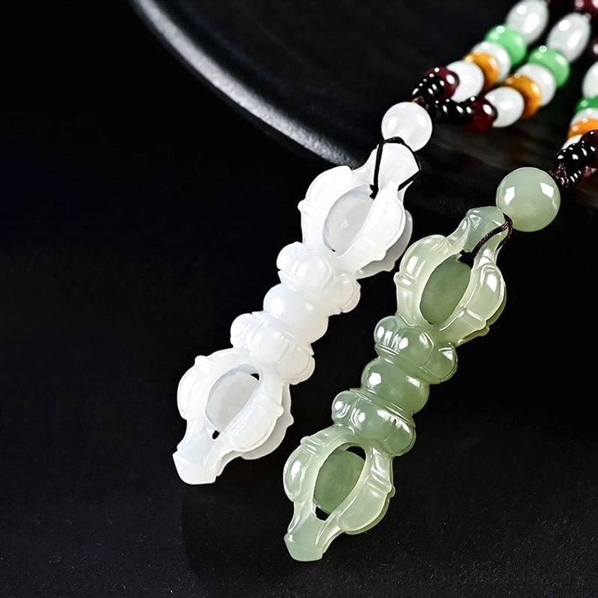 Hetian jade Dorje Vajra Buddhist pendant showing detailed hollow carved craftsmanship and natural jade translucency