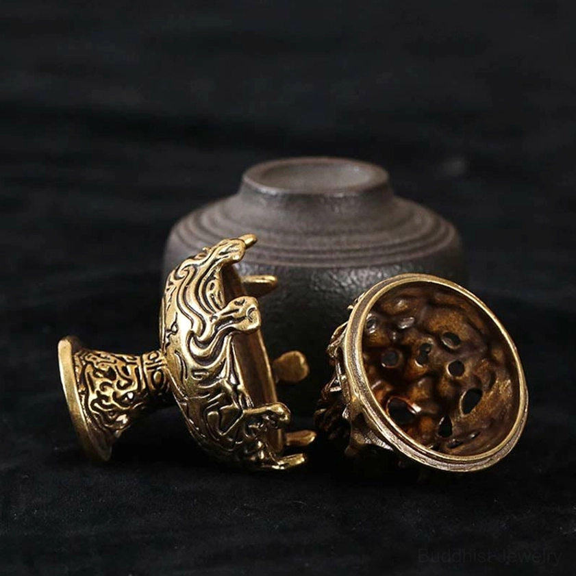 Handcrafted incense burner with hollowed relief design showing intricate scrollwork and mountain motifs in antique copper alloy finish