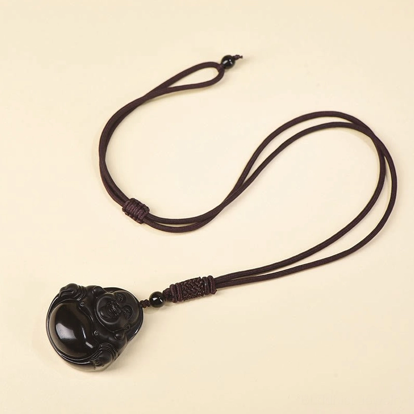 Ice obsidian Buddha pendant necklace with standard rope on neutral beige background
