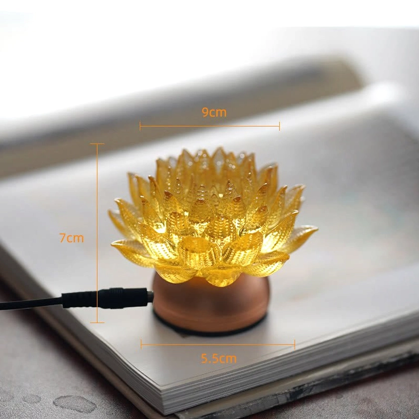 Illuminated lotus flower decoration, warm golden glow creating calm atmosphere for meditation
