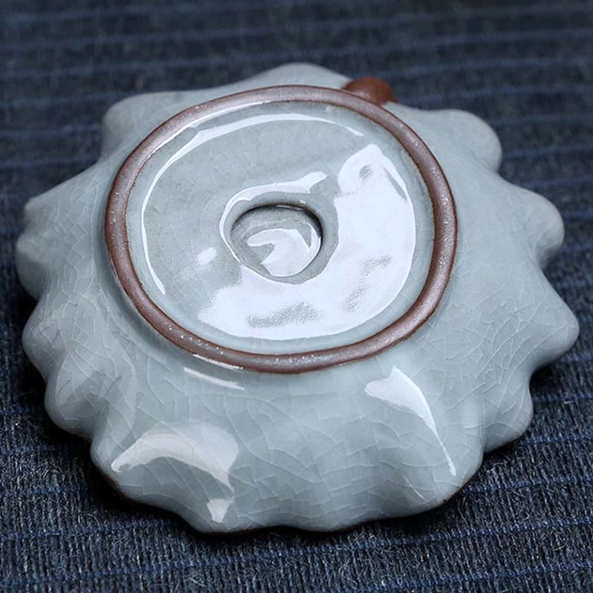 Bottom view of ceramic incense burner tray showing central drainage hole and brown glazed rim