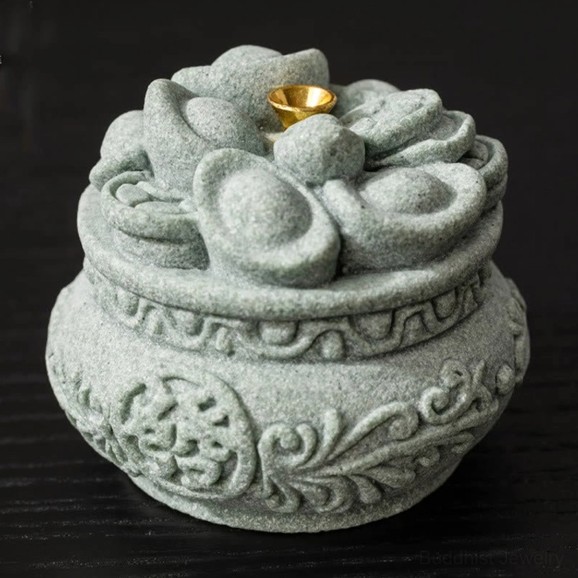 Handcrafted sandstone incense burner with prosperity symbols displayed as desk decoration