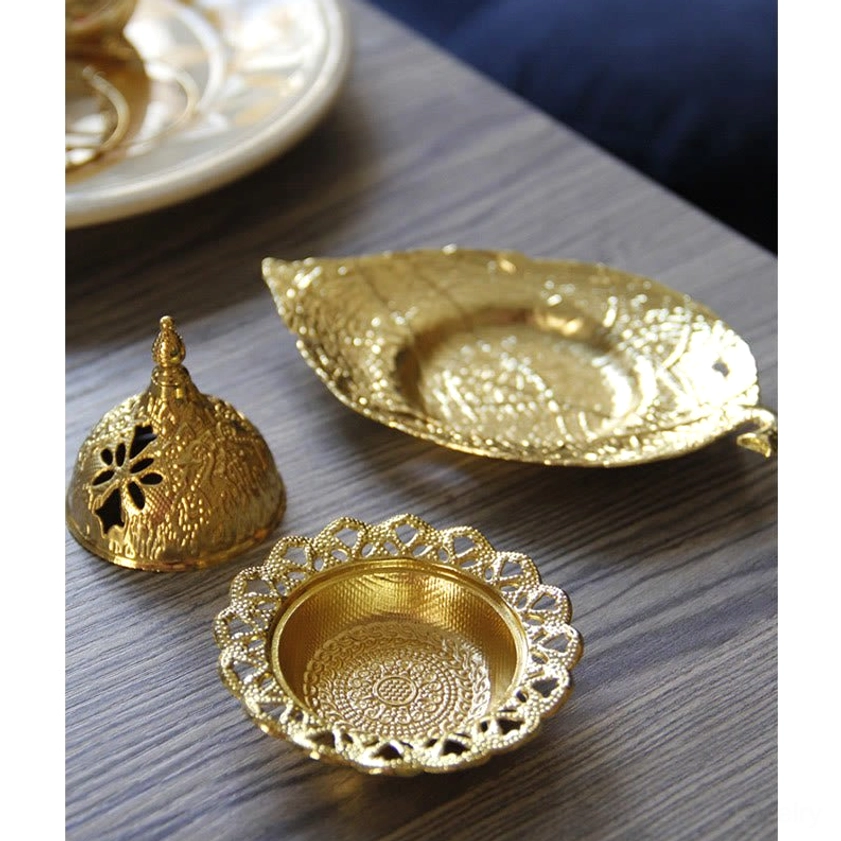 Disassembled incense burner set showing separated hollow carved lid, leaf-shaped tray and decorative base plate