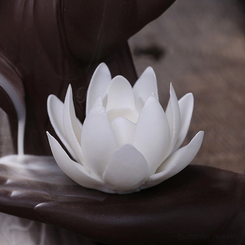 Detailed close-up of ceramic incense burner showing white lotus embellishment and smooth matte dark brown ceramic craftsmanship