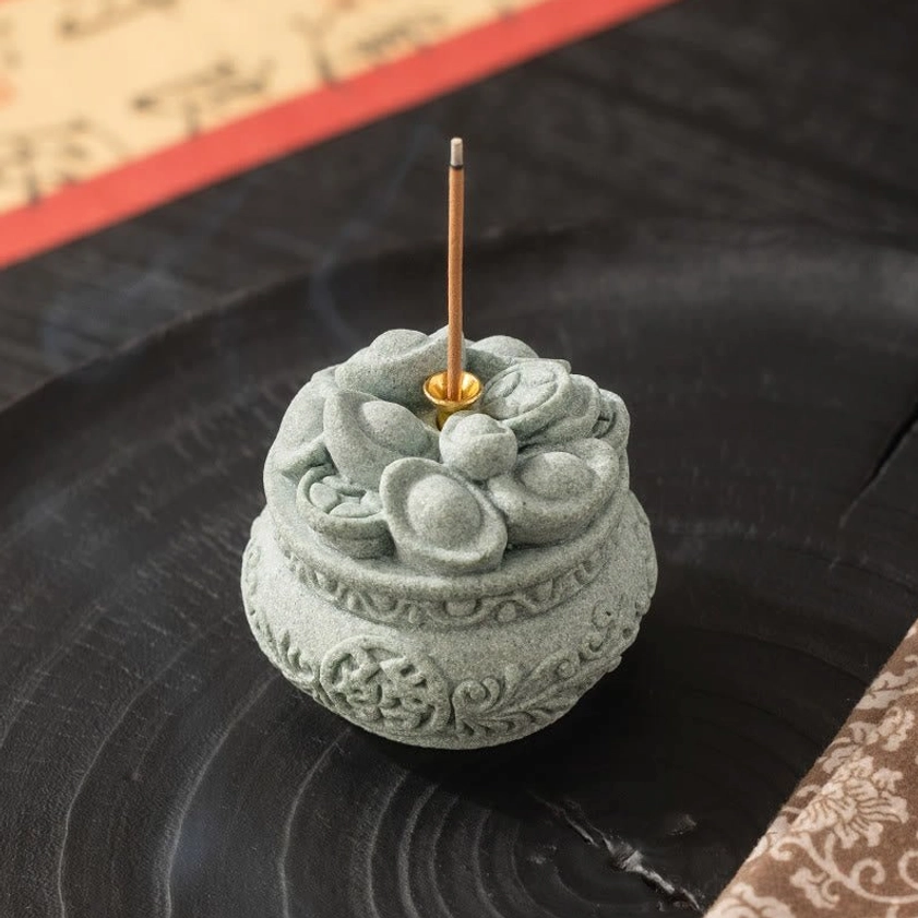 Buddhist incense burner with aromatic smoke showing spiritual meditation atmosphere and carved patterns