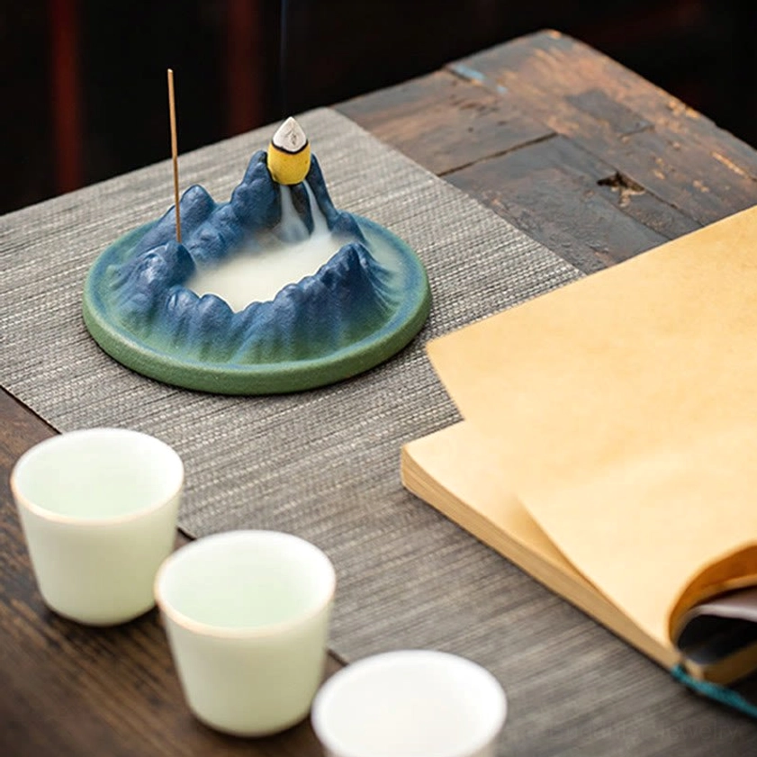 Top-down view of handcrafted ceramic backflow incense burner showing intricate mountain texture and peak crater for incense cone placement