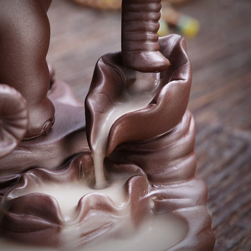 Detailed view of smoke trough and backflow channel in elephant incense burner, bottom angle