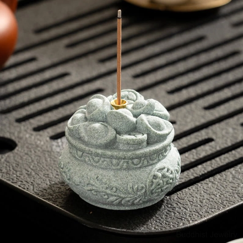 Buddhist incense holder on tea ceremony table showing traditional use and ambiance