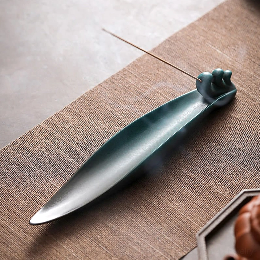 Buddhist ceramic incense holder detail shot showing hanging hole and glazed surface finish for meditation