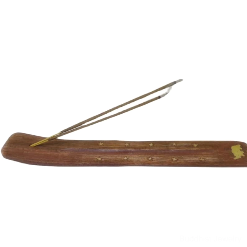 Buddhist wooden incense holder eye level view single incense stick gold star details