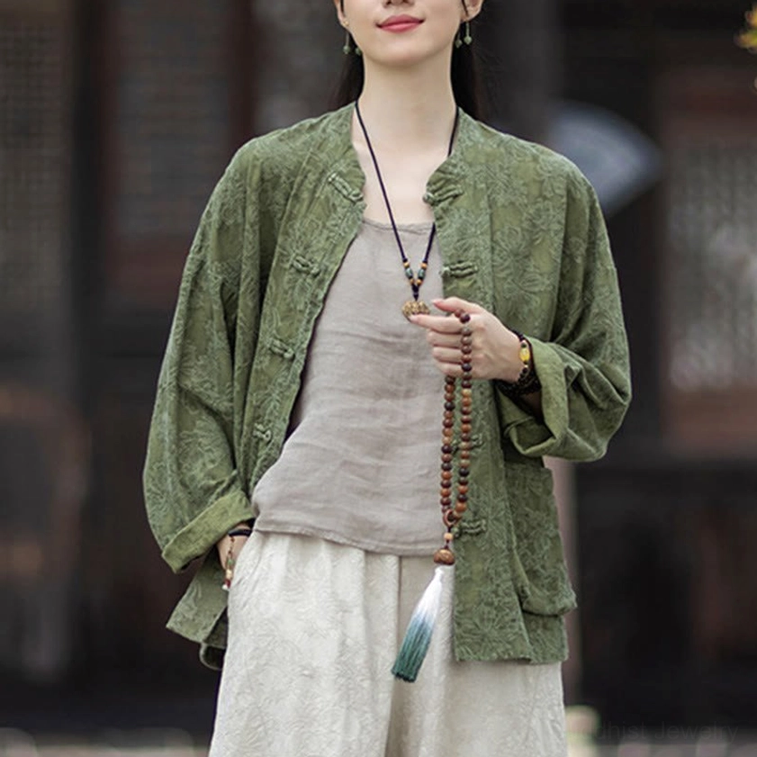 Three-quarter view showing loose fit jacquard shirt with beige inner layer and long pendant necklace