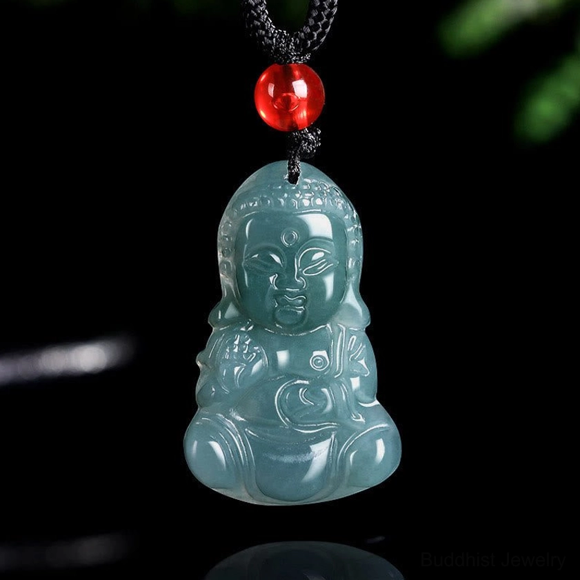 Straight front view of teal jade Buddha pendant with red glass bead and black rope necklace cord