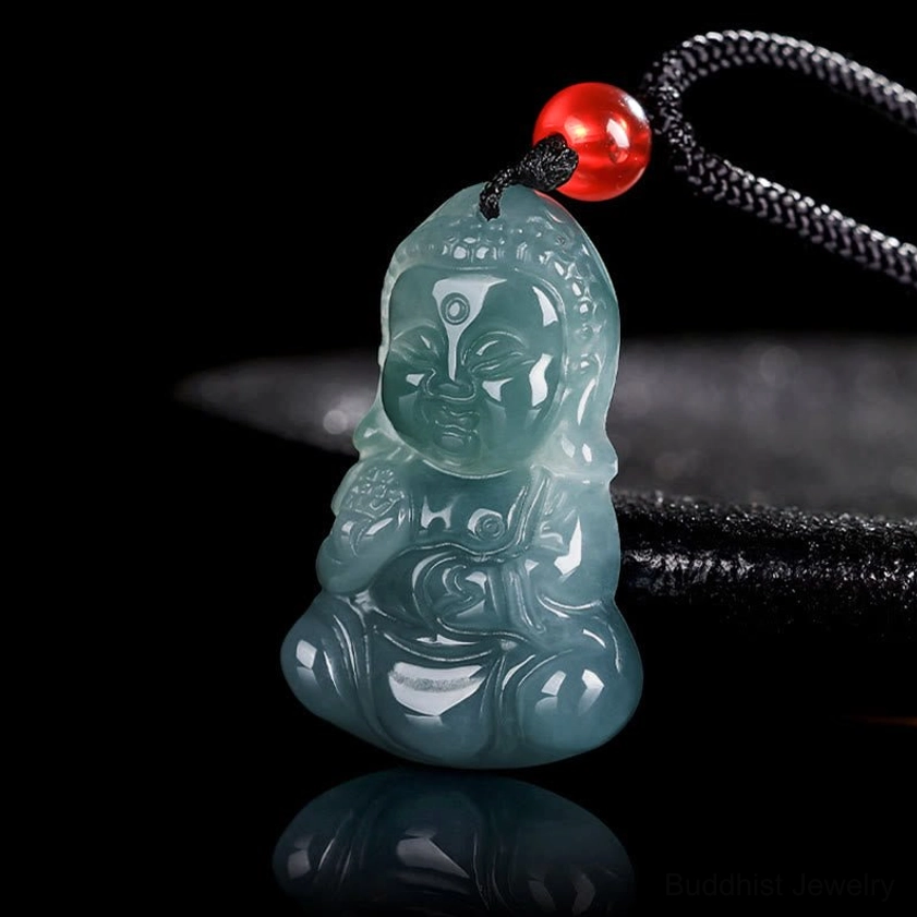 Three-quarter angle close-up of handcrafted jade Baby Buddha pendant showing smooth polished finish and black cord